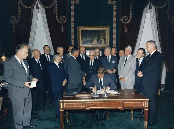 John Kennedy signs treaty banning nuclear weapons testing in the atmosphere