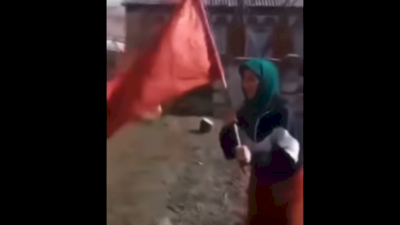 Symbol of struggle: Ukrainian old woman with a red flag "walks" across Russia